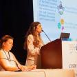   *Farah Massoud, MPH, speaking at a podium at CUGH 2024 Conference