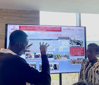 Discussing response to zoonotic outbreaks in Uganda during a poster presentation. David Mugume (UCSF) and Angella Musewa (AFROHUN Uganda)*