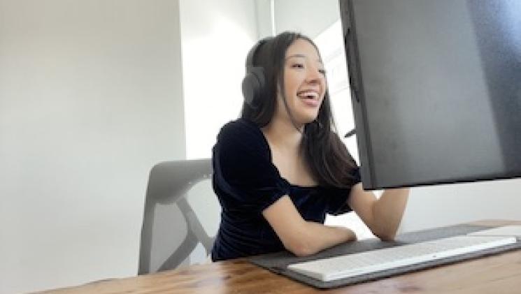 Person wearing headset interacts with people through a computer screen